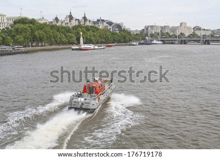 LONDON, ENGLAND - AUGUST 27, 2012: The London Fire Rescue Brigade boat is speeding along the Thames