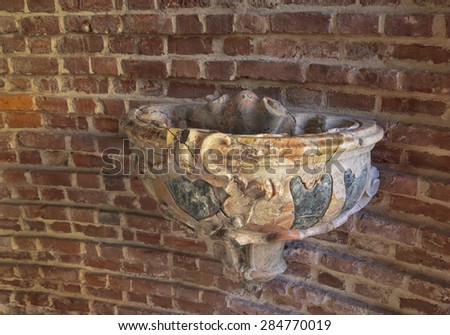 Medieval marble sink for the holy water in the Cathedral of Pavia, Italy