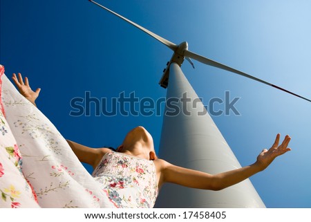 girl playing with the wind under a turbine