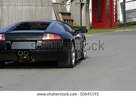 stock photo black lamborghini gallardo supercar on the road