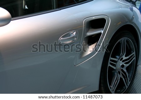 rear quarter of shiny silver german performance car