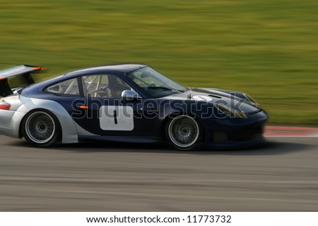 porsche race car on track with blurred background