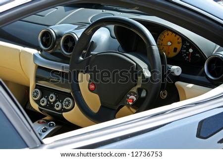 looking at a super car dash and steering wheel through the passenger window