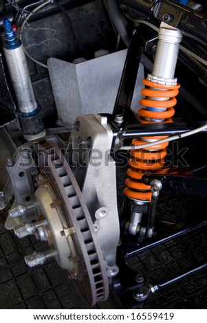 race car brake disk and orange shock absorber