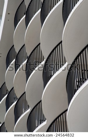 curved white hotel balconies with black iron railings