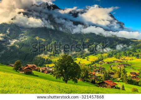 Green fields and famous touristic town with high North Face of Eiger mountains,Bernese Oberland,Switzerland,Europe
