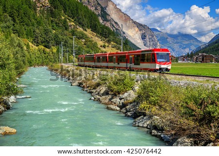 Famous electric red tourist train in Tasch,Valais region,Switzerland,Europe