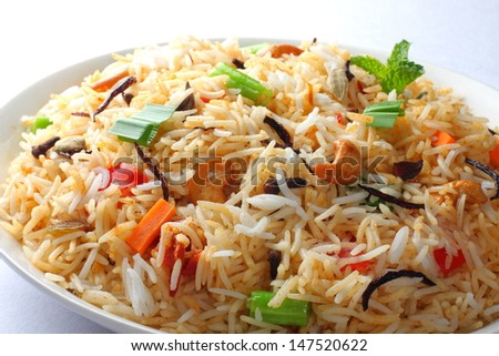 Close up view of The Indian Pulav- It is a medley of rice, vegetables and/or meat. The Basmati  rice is browned in oil and then mixed with vegetables, egg, chicken , nuts, fruits etc.
