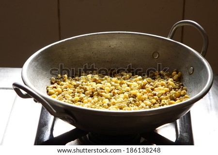 Food cooking in a traditional aluminum  pan on stove .