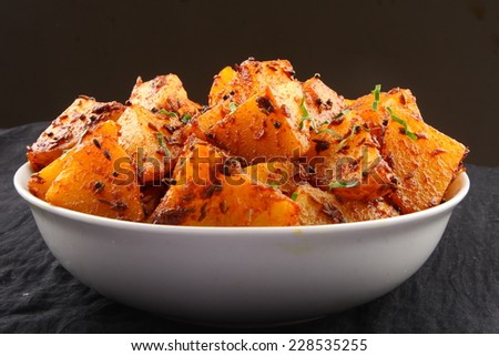 Fried potatoes with herbs and spices.shallow depth of field photograph.