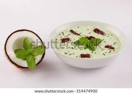 Coconut chutney served with raw coconut and fresh mint.