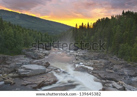 A stunning sunset on a river in the wildlife in Norway