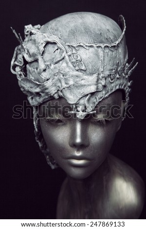 Mannequin in grey stone head wear on black background