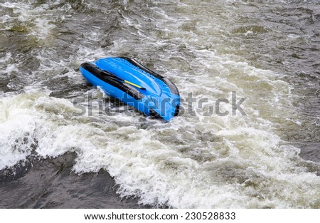 upside down raft on fast moving water with  people missing