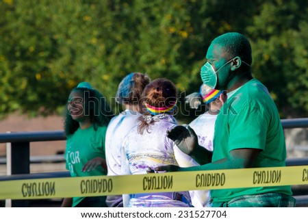 Indiana, South Band - September 26, 2014: workers,  coated in green powder, cover runners in color as they participate in a colorful 5k race called the color run, in south bend Indiana