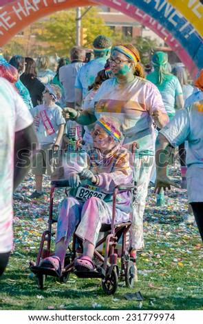 South Bend Indiana, September 26, 2014; people of all ages,  walking, running,  and even in wheel chairs, have fun as they participate in the  colorful, fun 5k  race called the color run