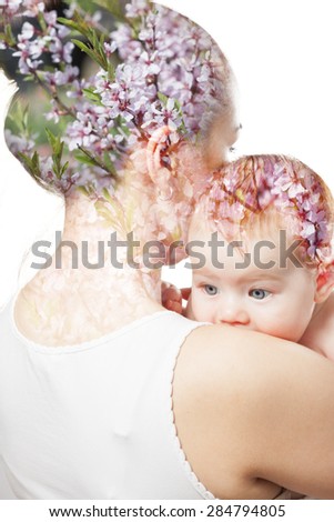 double exposure . mothers hugging baby on a background of beautiful flowers