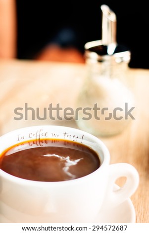 cup of coffee with milk. morning in the coffee shop. rural style . focus on the inscription \