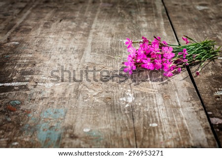lovely bouquet of wild flowers on a textured board. focus on the petals of a flower. there is room for designer labels . Picture perfect for greetings and announcements