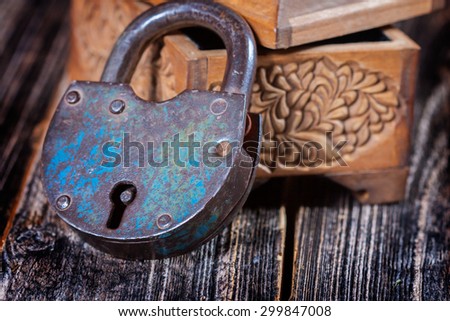 old lock and wooden box on board texture . excellent photos for the background . focus on lock. closeup