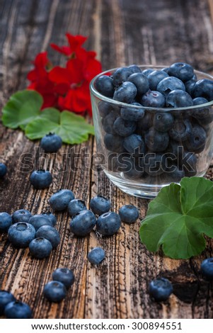 blueberries in a glass. ripe sweet berry . environmentally friendly product. country style. focus on berries scattered on the board