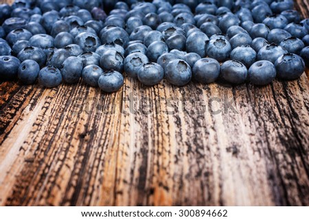 blueberries sprinkled . textured board . natural eco-friendly product . healthy food and vitamins. rural style . blueberries closeup