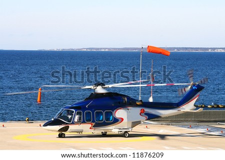 Helicopter on the platform near the sea.