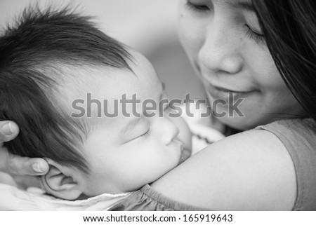 Black and White Happy asian mother with adorable cute baby