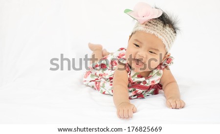 asian cute baby girl smile with big rose headband