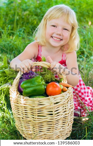 Child with basket full of vegetables
