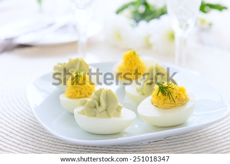 Eggs stuffed with cheese and avocado mousse