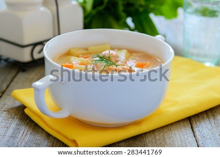 Salmon soup with cream, potatoes, carrots, dill