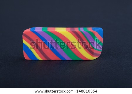 Rainbow colored eraser on the black background