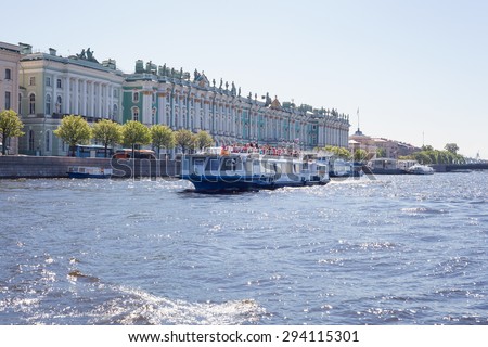 Saint Petersburg, Russia - May 30, 2015: Excursion boat on Neva river against Hermitage building