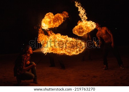 SAINT-PETERSBURG, RUSSIA - SEPTEMBER 19, 2014 : A group of firedancers perform fire breathing  on \