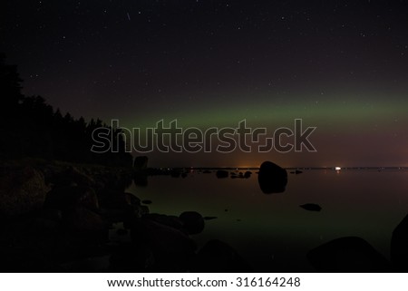 Aurora borealis above dark waters o the Gulf of Finland