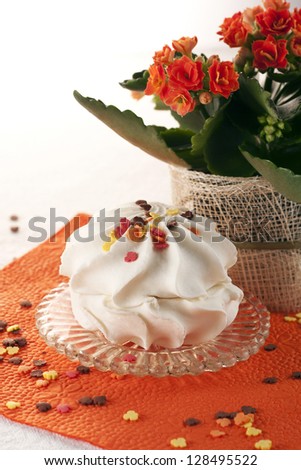 Marshmallow dessert on a red napkin with a flower in the background