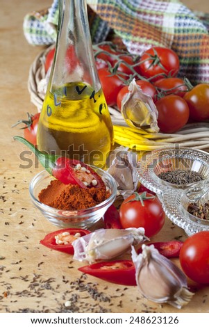 Garlic, chili pepper, paprika, olive oil and tomatoes as cooking ingredients