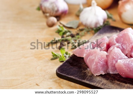 Layout of raw ingredients for fricassee including meat, herbs and spices with place for text