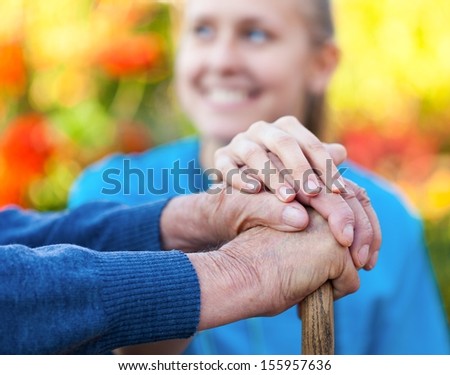 Young female doctor holding his patient hand.
