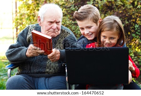 Grandfather threating his grandchildren with a book, trying to convince them to read.