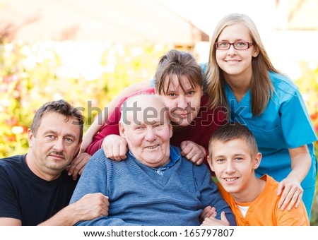 Caring doctor together with her patient\'s family.