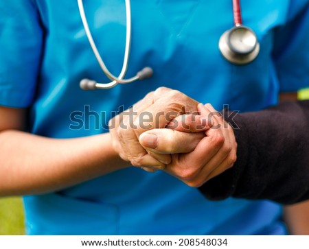 Doctor helping old patient with Alzheimer\'s disease.