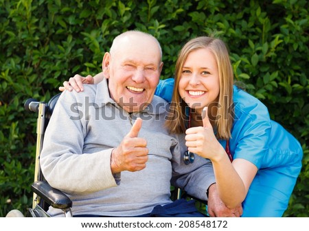 Happy smiling patient showing thumbs up together with his doctor.