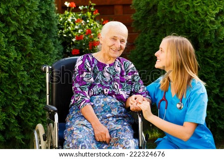 Contented old woman with her kind doctor at the nursing home.