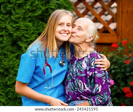 Kind young doctor being admired and loved by elderly patient.