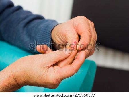 Close-up of an old man\'s hand after blood sugar test.