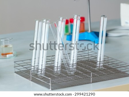 Prepared empty test tubes on laboratory desk for chemical experiments.