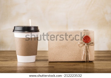 Vintage craft paper cup and package on wooden table