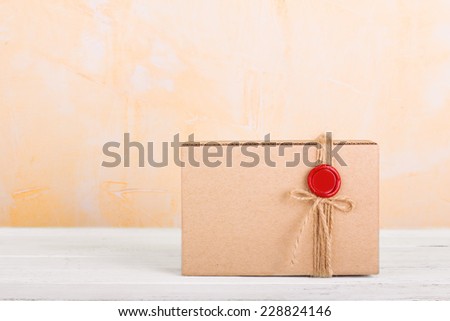 gift box with a red seal on wooden background
